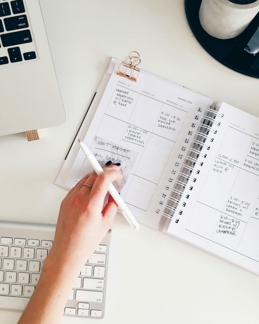 person-holding-notepad-and-pen-flat-lay-photography.jpg person holding notepad and pen flat lay photography